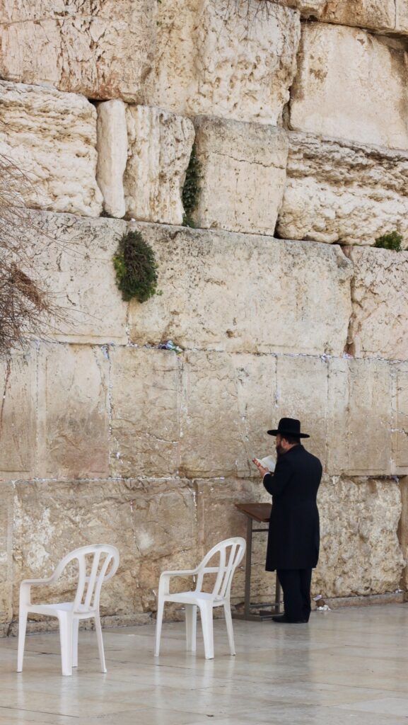 Man praying at Western Wall- a Modern Day Prayer Board